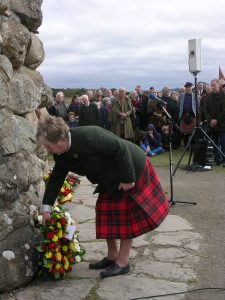 Ann laying a wreath at Culloden